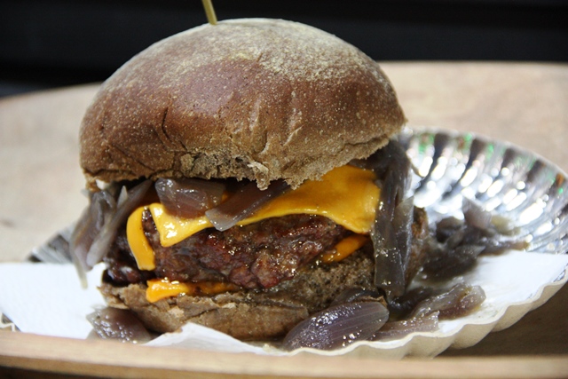 Black Beef com pão australiano (preto e agridoce) e recheado com Burger artesanal bovino, double de cheddar e cebolas caramelizadas